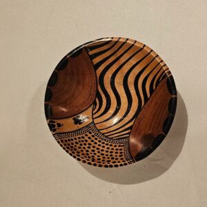 African handmade wooden bowl with an intricate hand-painted design, perfect for serving or as a decor piece.