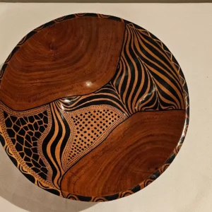 Hand-painted African wooden bowl with a geometric design.