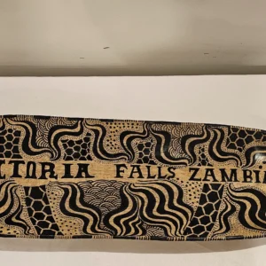 Hand-carved wooden serving tray with black tribal patterns, perfect for home decor.